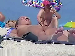 Nude beach with a sexy couple in focus